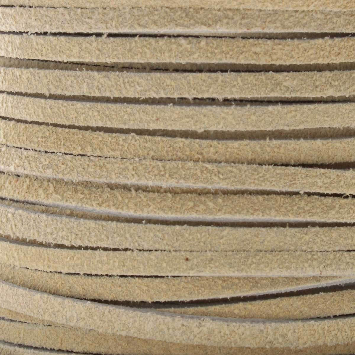 Close-up of beige leather cord with visible texture