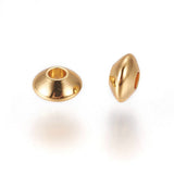 Two gold beads on a white background