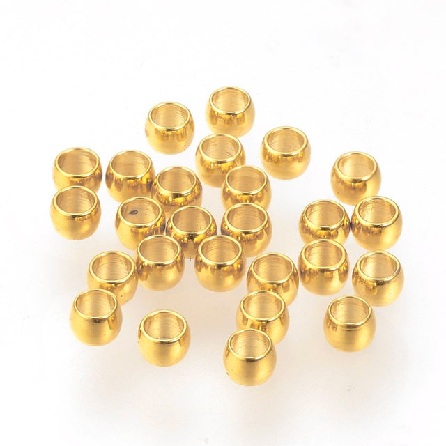 anti tarnish surface on gold crimping beads shown on a white background