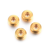 Four gold beads on a white background