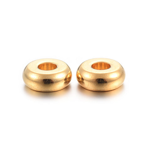 Two gold beads on a white background