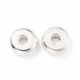 Two silver beads on a white background