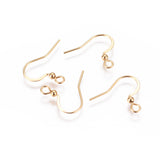 close up of a collection of gold anti tarnish ear wires with a white background a