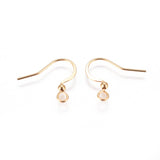 close up of a collection of gold anti tarnish ear wires with a white background 