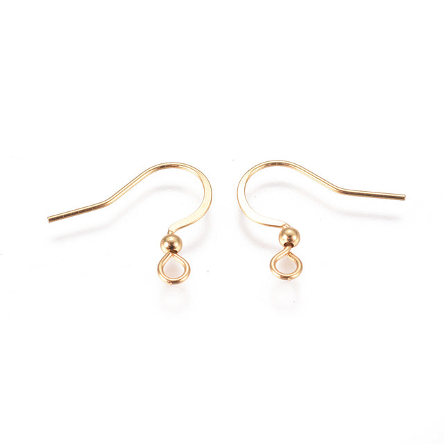 close up of a collection of gold anti tarnish ear wires with a white background 
