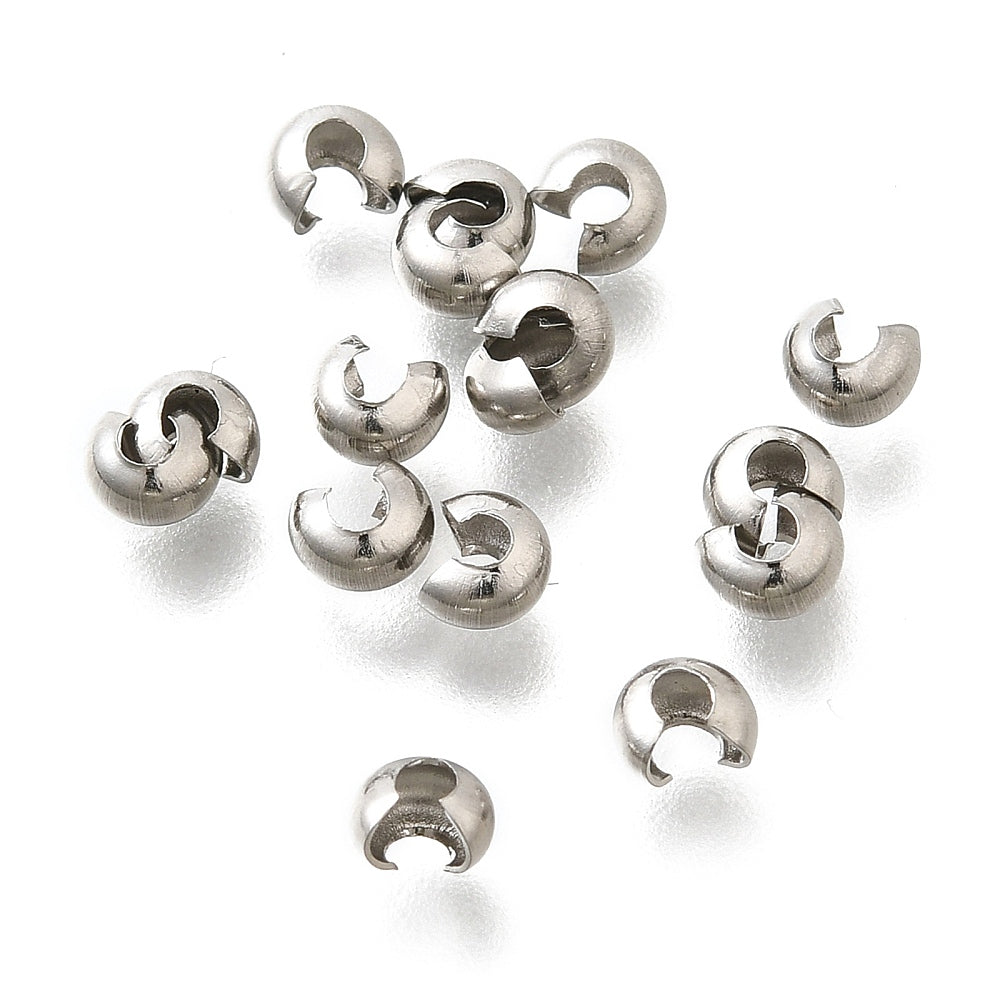 a collection of anti tarnish finished crimp cover beads on a white background