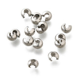 a collection of anti tarnish finished crimp cover beads on a white background