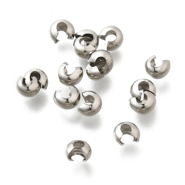 a collection of anti tarnish finished crimp cover beads on a white background