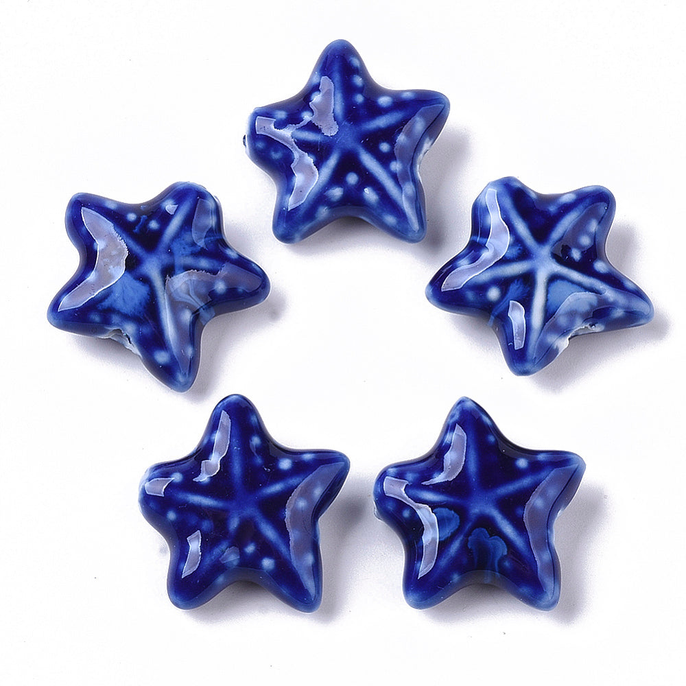Five blue star-shaped starfish beads on a white background