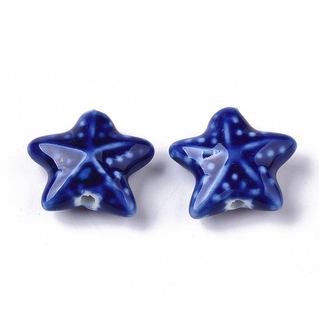 Two blue star-shaped starfish beads on a white background