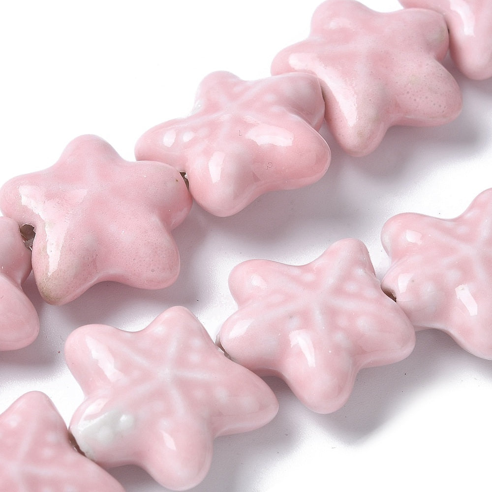 Pink star-shaped beads on a white background