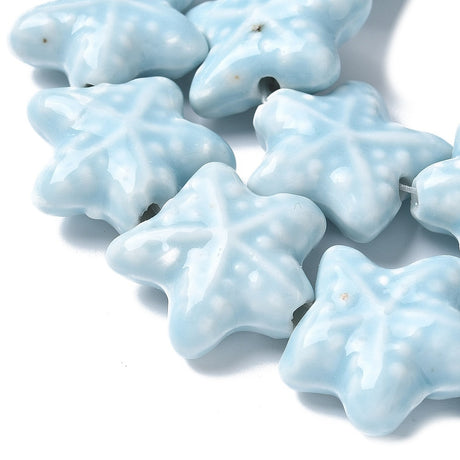 Starfish Star-shaped light blue beads on a white background