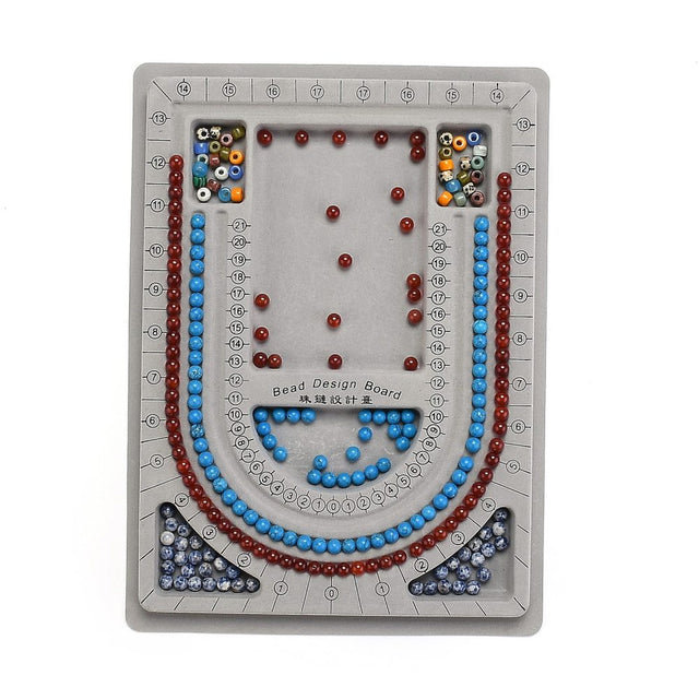 Bead design board with colorful beads arranged in a decorative pattern on a white background.