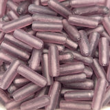 Close-up of purple cylindrical beads with visible threading hole for making jewelry or craft.