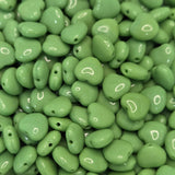 Close-up of green heart-shaped beads with a glossy finish.