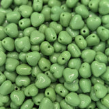 Green heart-shaped beads on a plain background