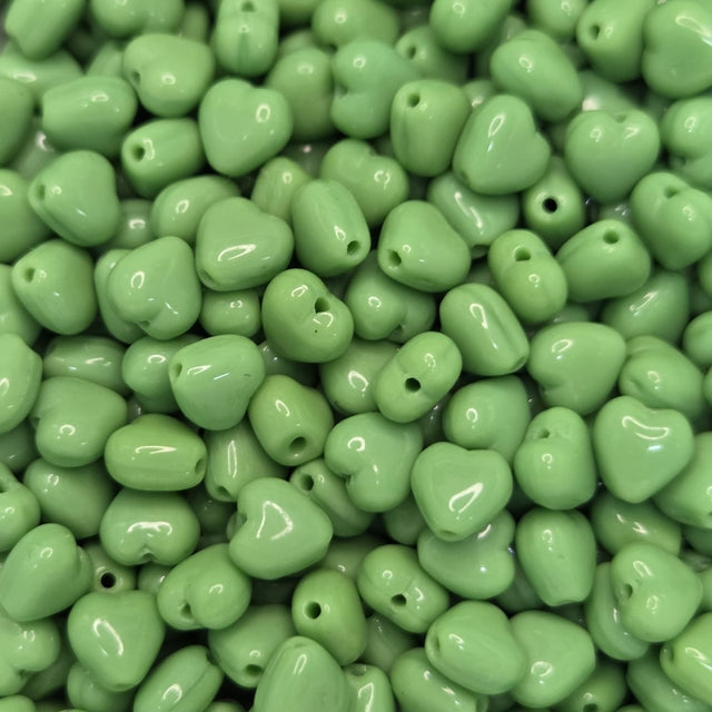 Green heart-shaped beads on a plain background