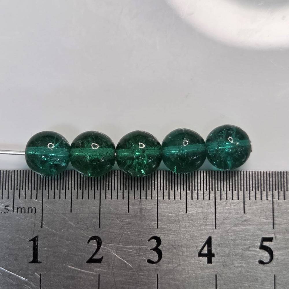 Green beads on a ruler for size reference