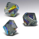 Three faceted crystal beads on a gradient gray background