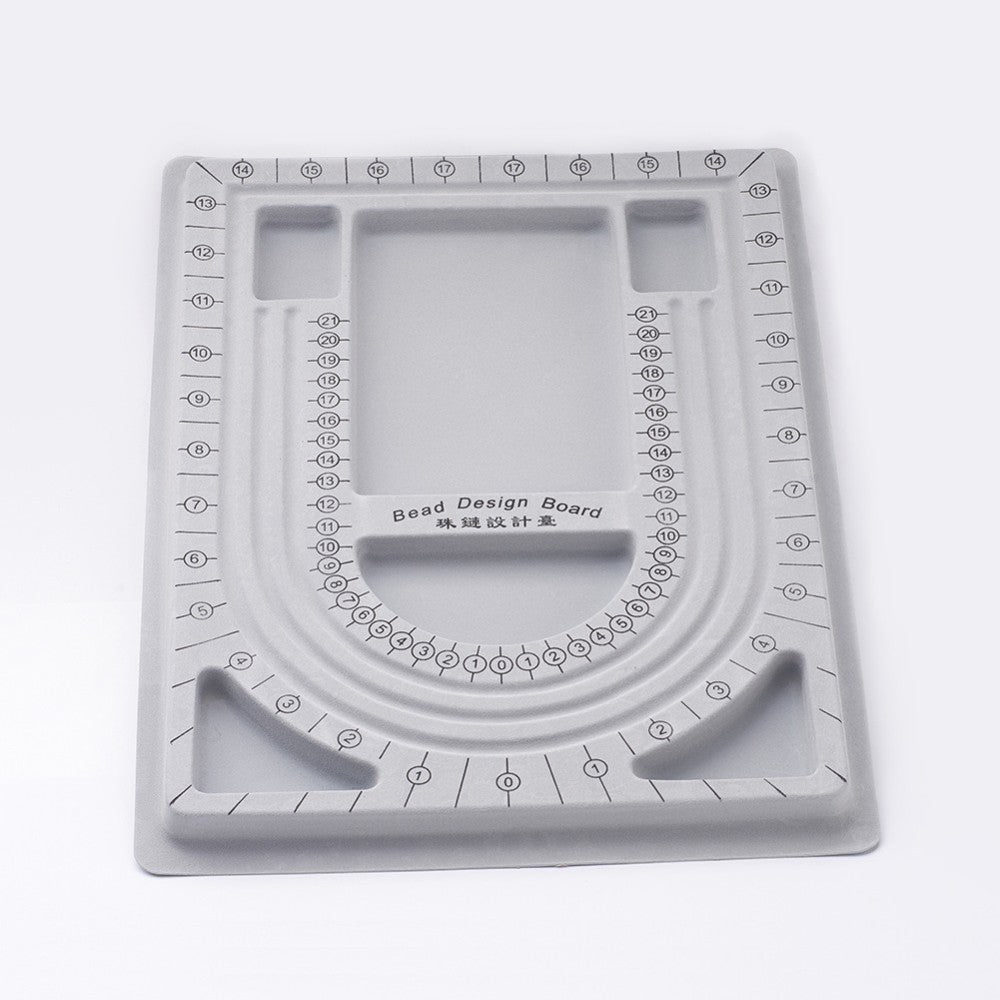 Gray bead design board with measurement markings on a white background