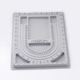 Gray bead design board with measurement markings on a white background