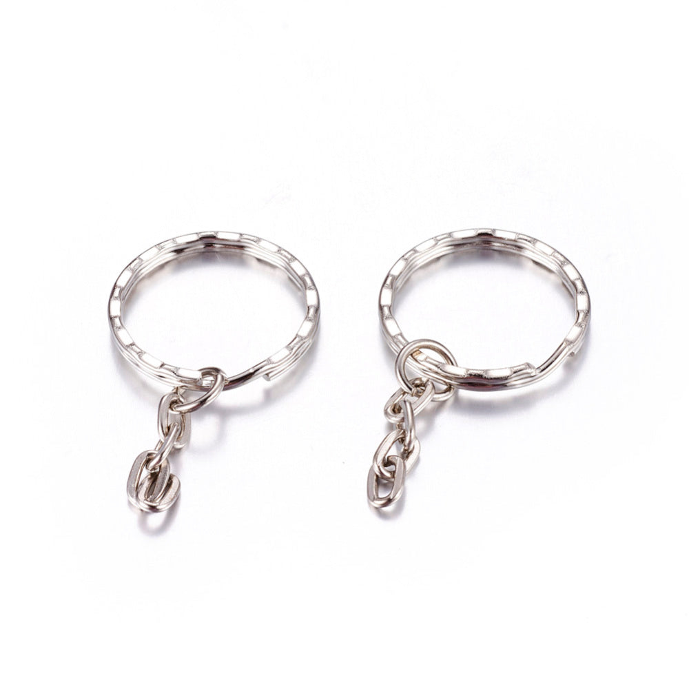 Two silver keychains with small chains on a white background