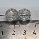 Two faceted crystals on a ruler for size reference