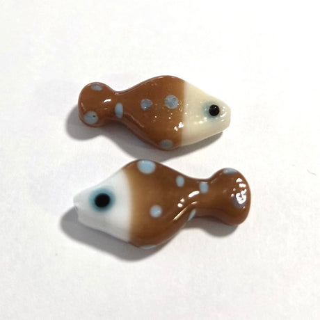 Two fish-shaped glass beads with brown and white pattern on a white background