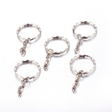 Five silver keychains with chain attachments on a white background