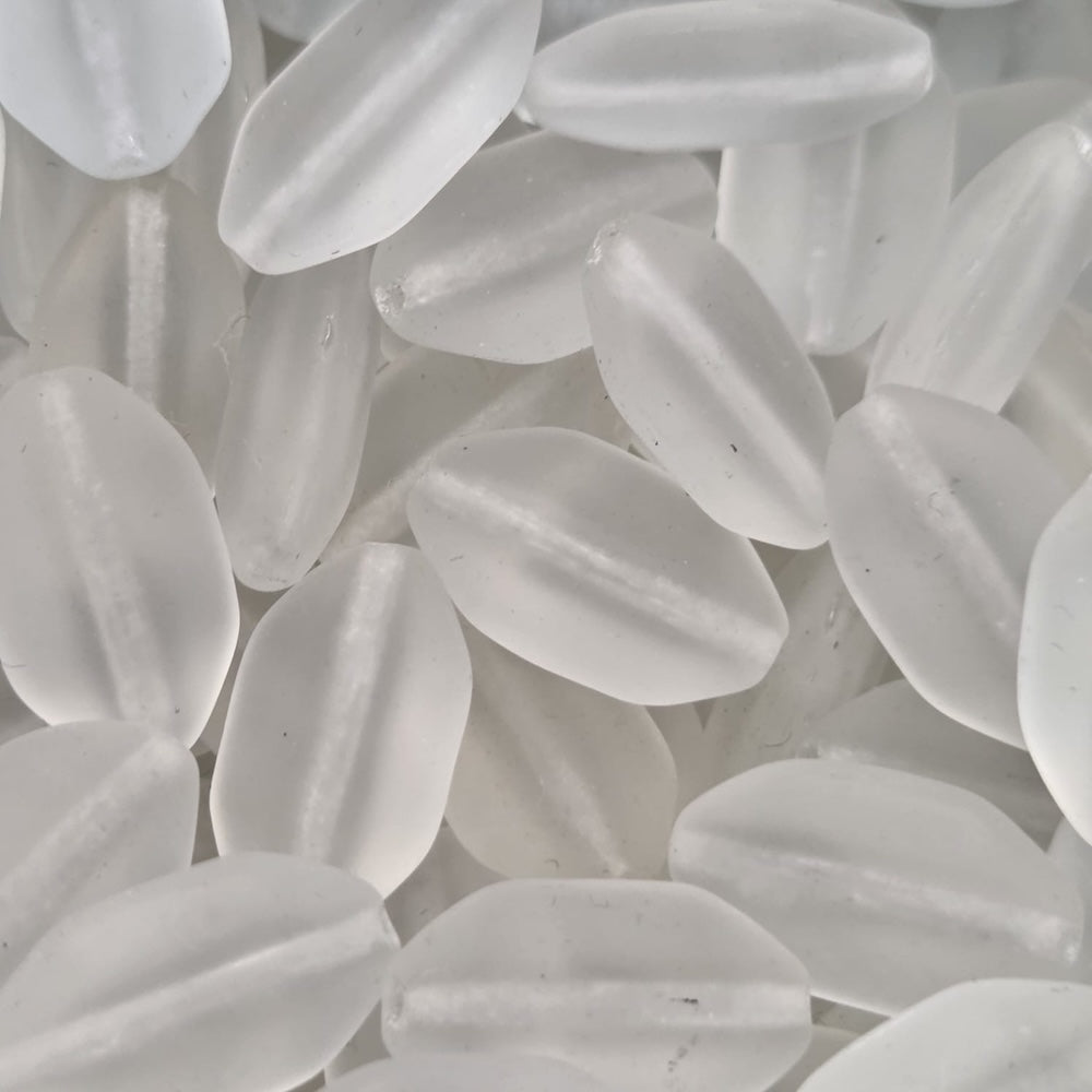 Close-up of white shield-shaped beads with a blurred background