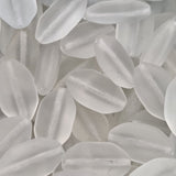 Close-up of white shield-shaped beads with a blurred background