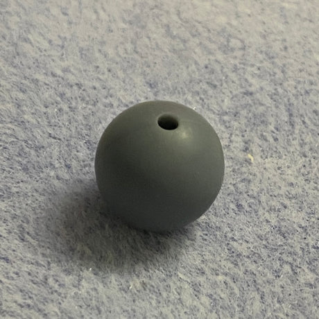 gray silicone bead on a gray textured surface