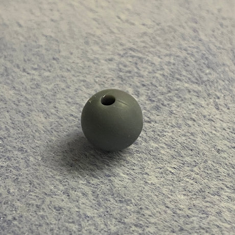 Gray rubber bead on a textured gray surface
