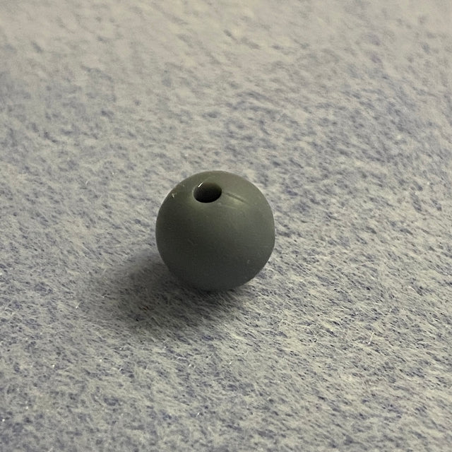 Gray rubber bead on a textured gray surface