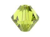 Faceted yellow-green crystal bead on a white background