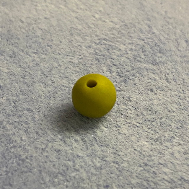 mustard silicone bead on a gray textured surface