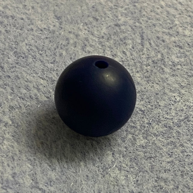 navy blue silicone bead on a gray textured surface