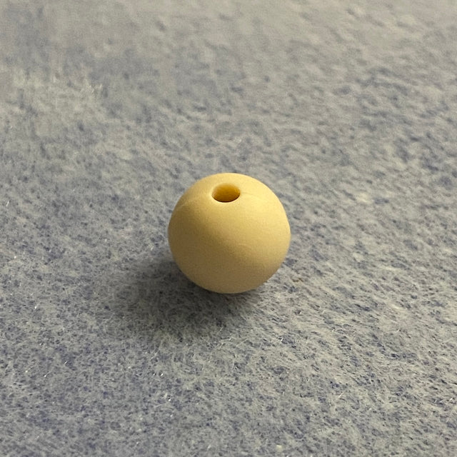 neutral nude colour silicone bead on a gray textured surface