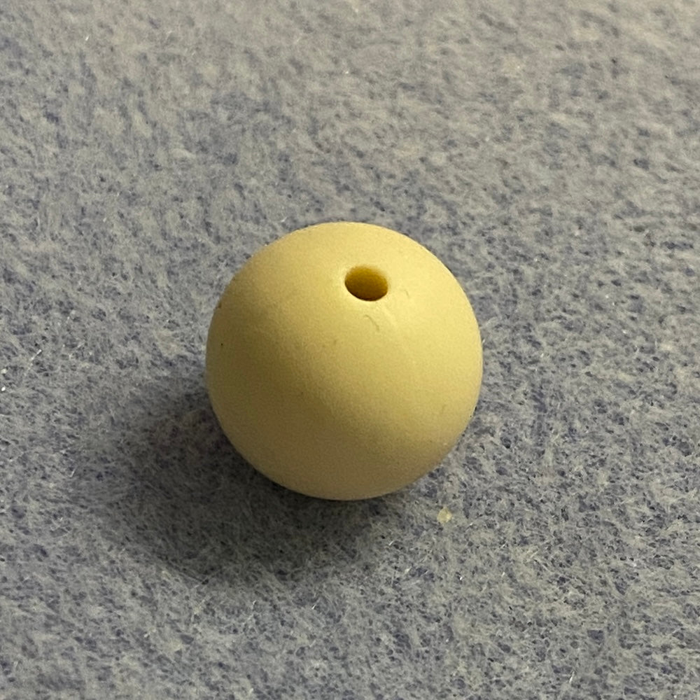 neutral nude silicone bead on a gray textured surface
