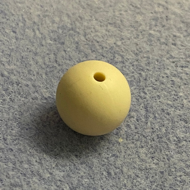 neutral nude silicone bead on a gray textured surface