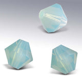 Three pale light blue faceted crystal beads on a white background