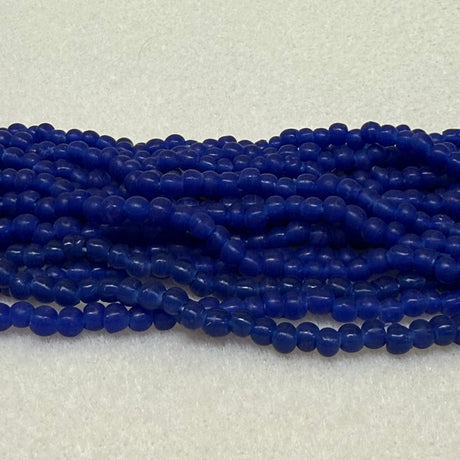 Strings of blue round beads on a light gray background