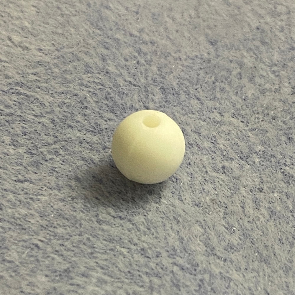 white silicone bead on a gray textured surface