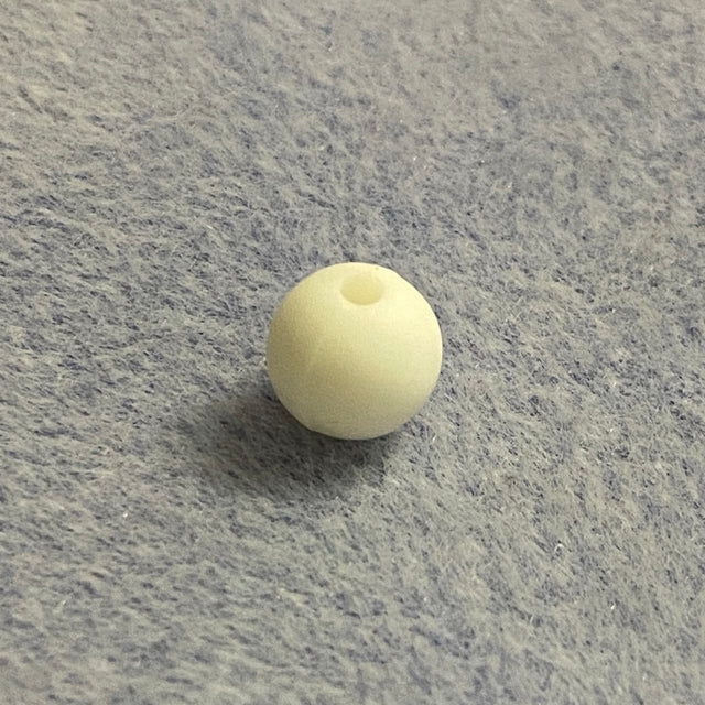 white silicone bead on a gray textured surface