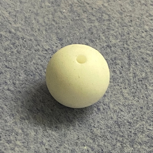 white silicone bead on a gray textured surface