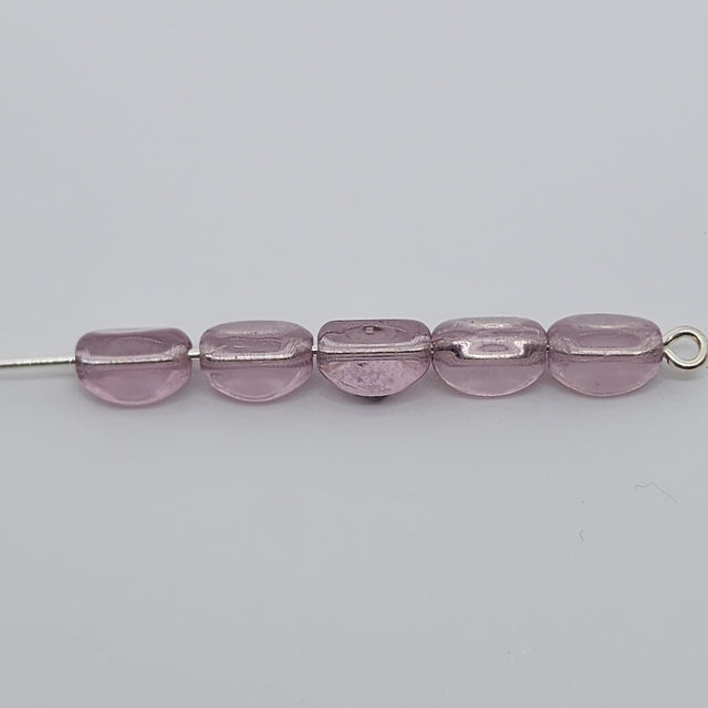 pinched rice light purple beads on a pin with a white background