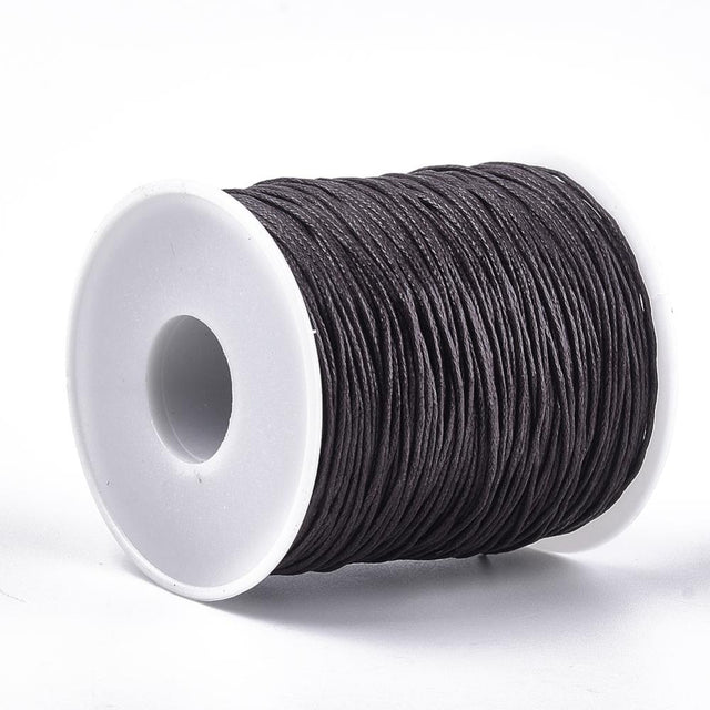 A spool of waxed cotton cord in brown color for crafting and jewelry making.